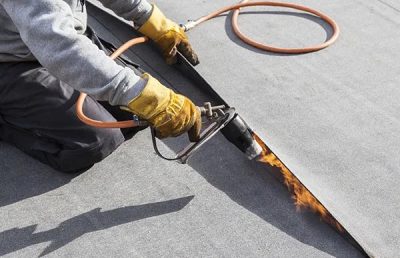 A roofer working with Modified Bitumen Roofing