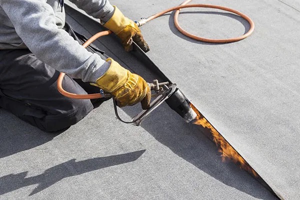 A roofer working with Modified Bitumen Roofing